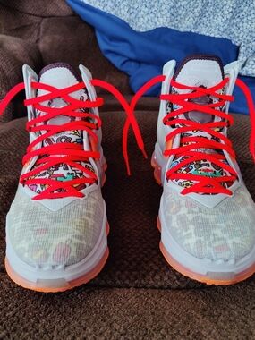 Light White Athletic Sneakers with Bright Red Laces and Orange Accents